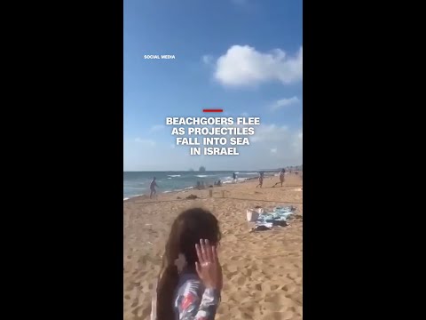 Beachgoers flee as projectiles fall into sea in Israel thumbnail