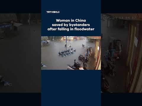 Woman in China saved by bystanders after falling in floodwater thumbnail