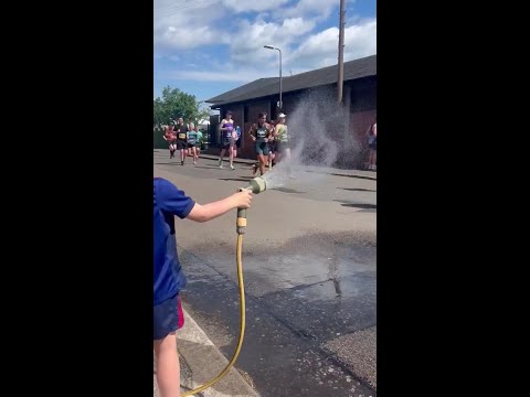 Little Hero' Hoses Down Marathon Runners During Heatwave thumbnail