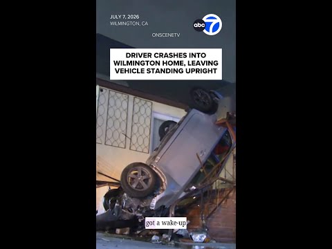 Driver crashes into home, leaving car standing upright thumbnail