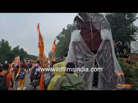 Kanwar Yatra pilgrims travel toward Haridwar along a busy highway thumbnail