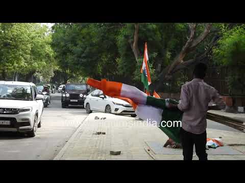 Indian flags on sale in busy city street market thumbnail
