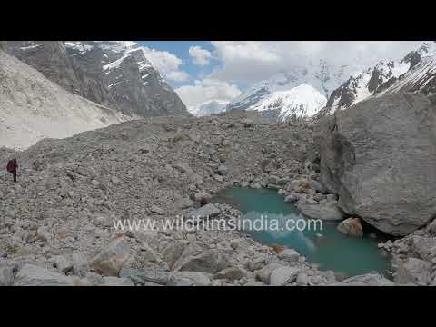 Chaukhamba trek hikers on boulder-strewn Himalayan trail thumbnail
