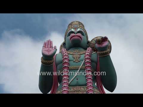 Huge statue of Hanuman at Agara Temple under shifting clouds in Bengaluru thumbnail
