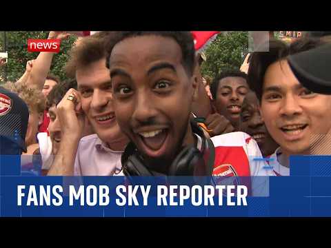Arsenal fans gatecrash Sky News reporter's live broadcast thumbnail