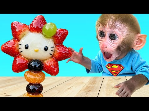 Monkey Baby Bon Bon with the puppy sat together on the wooden cart in the cold snowy weather thumbnail