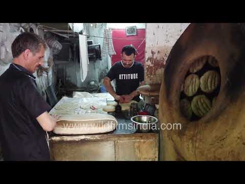 Afghan bakers preparing traditional naan inside Delhi tandoor bakery thumbnail